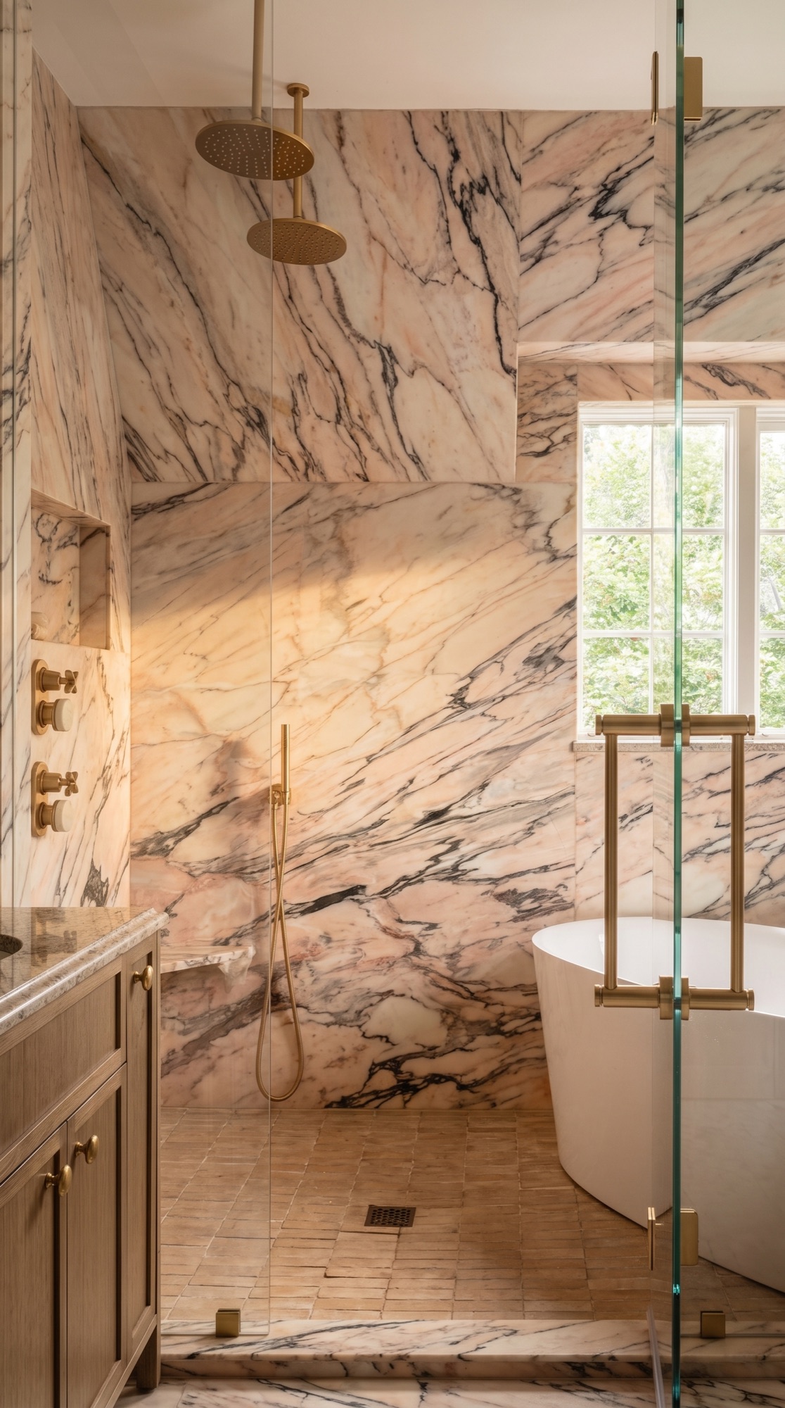 Luxury shower clad in Calacatta Rosa pink marble with brushed brass fittings