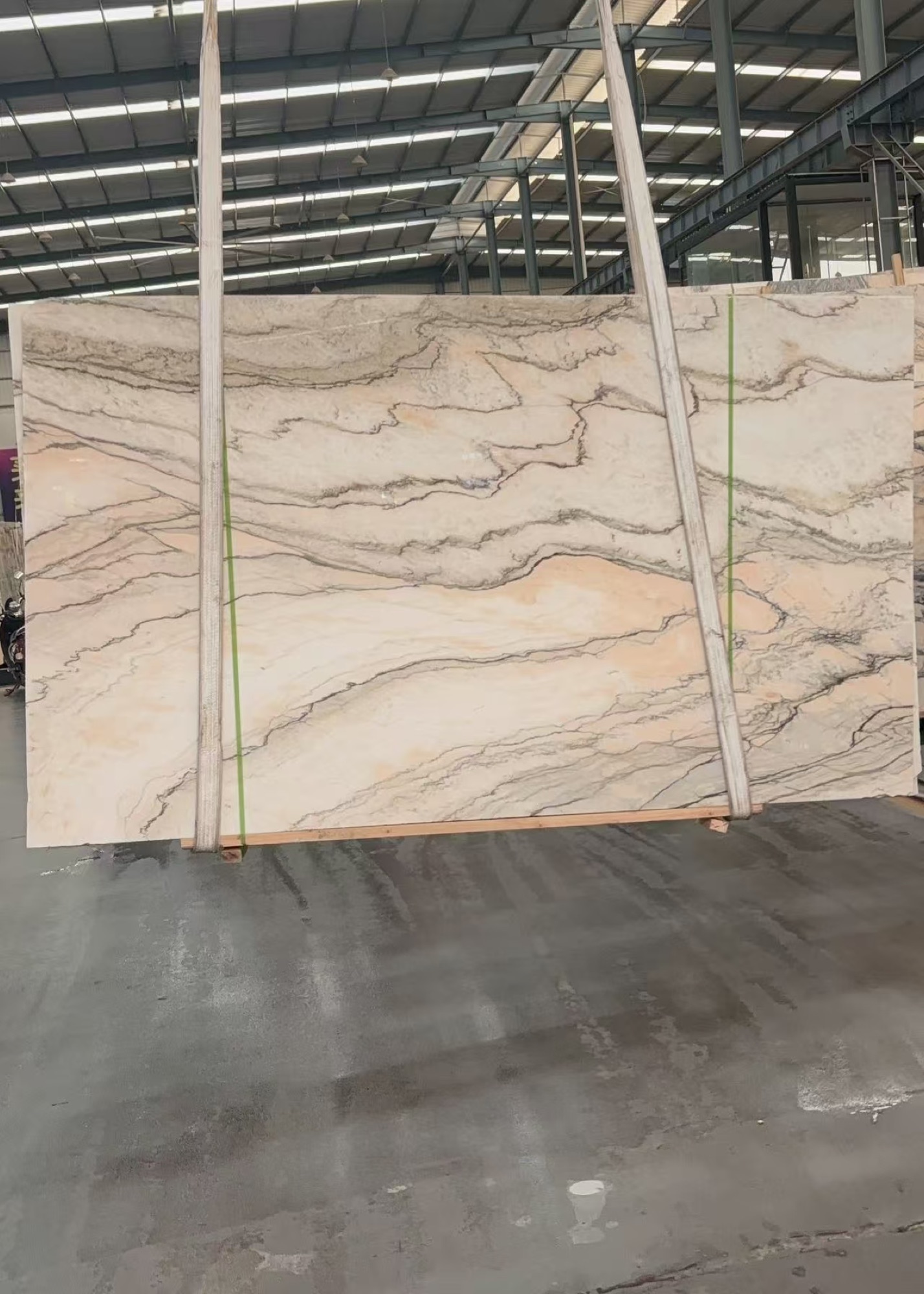 Full Calacatta Rosa slab showing a pale blush field with warm grey and brown movement