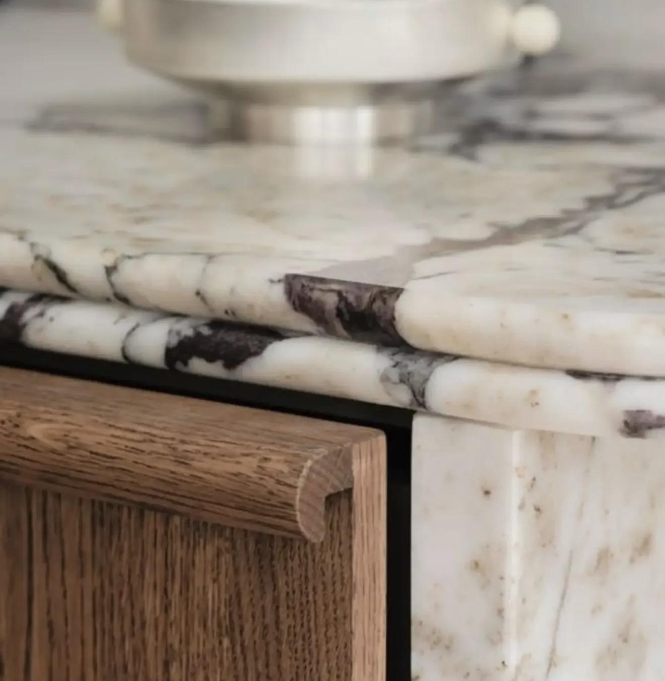 Close-up comparison of rounded bullnose marble countertop edge profiles