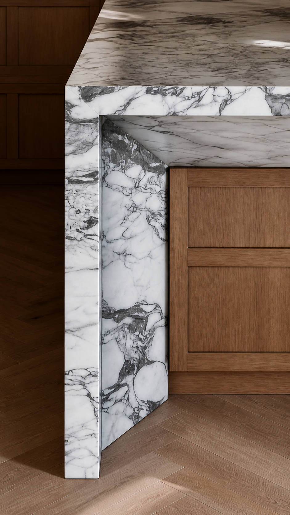 Close view of a white marble mitered waterfall countertop with a recessed undercut detail