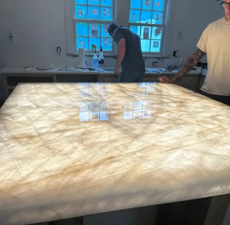 Warm backlighting glowing evenly through a Cristallo quartzite kitchen worktop