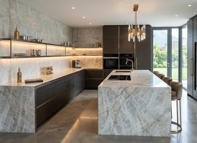 Cristallo quartzite waterfall island and worktops in a modern dark-cabinet kitchen