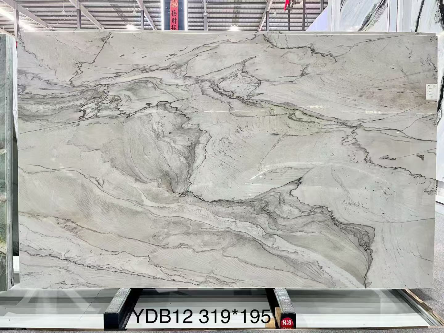 Infinity White quartzite slab with long flowing grey veins on a soft white background