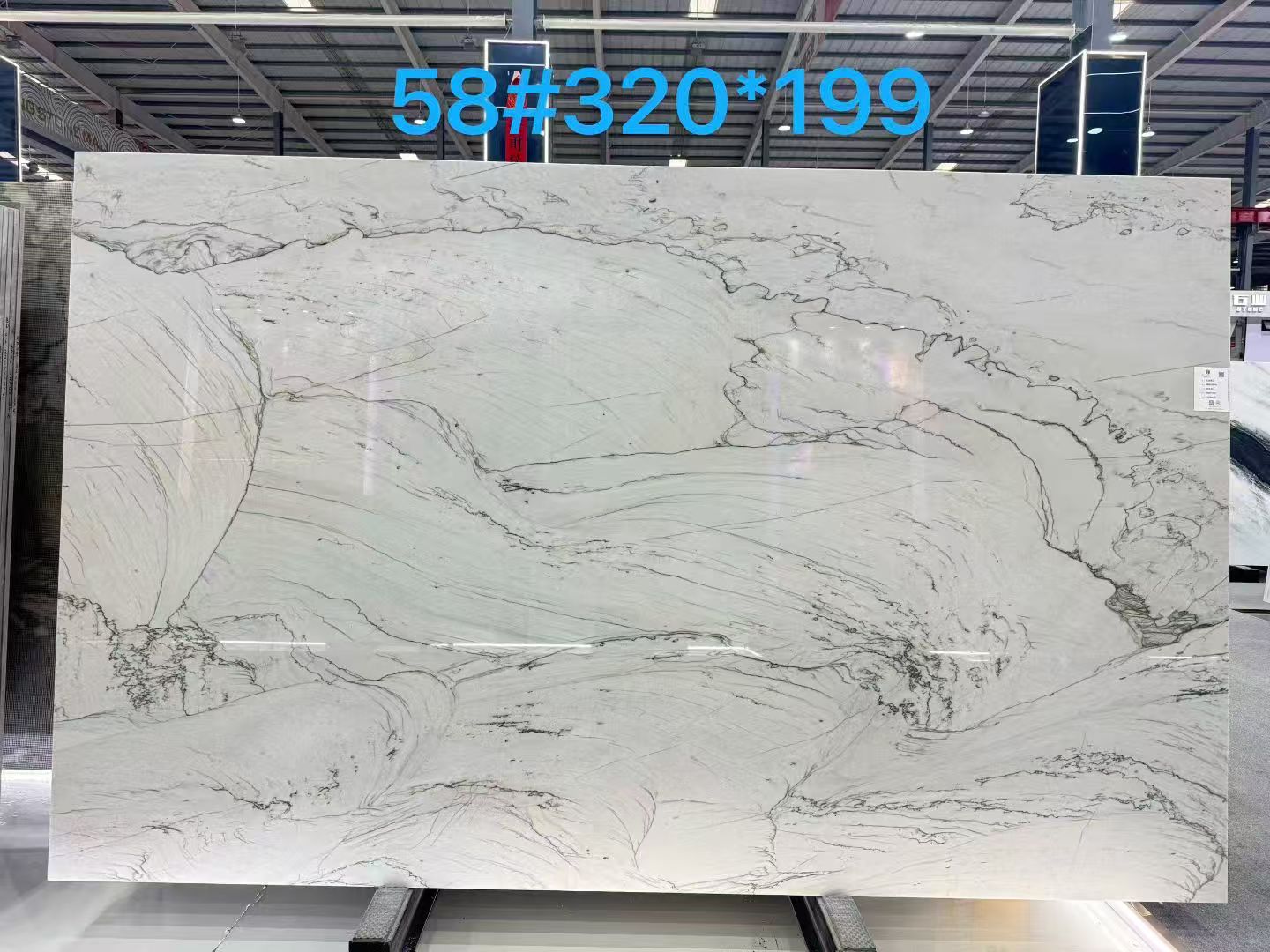 Infinity White quartzite slab with a pale background and delicate grey linear movement