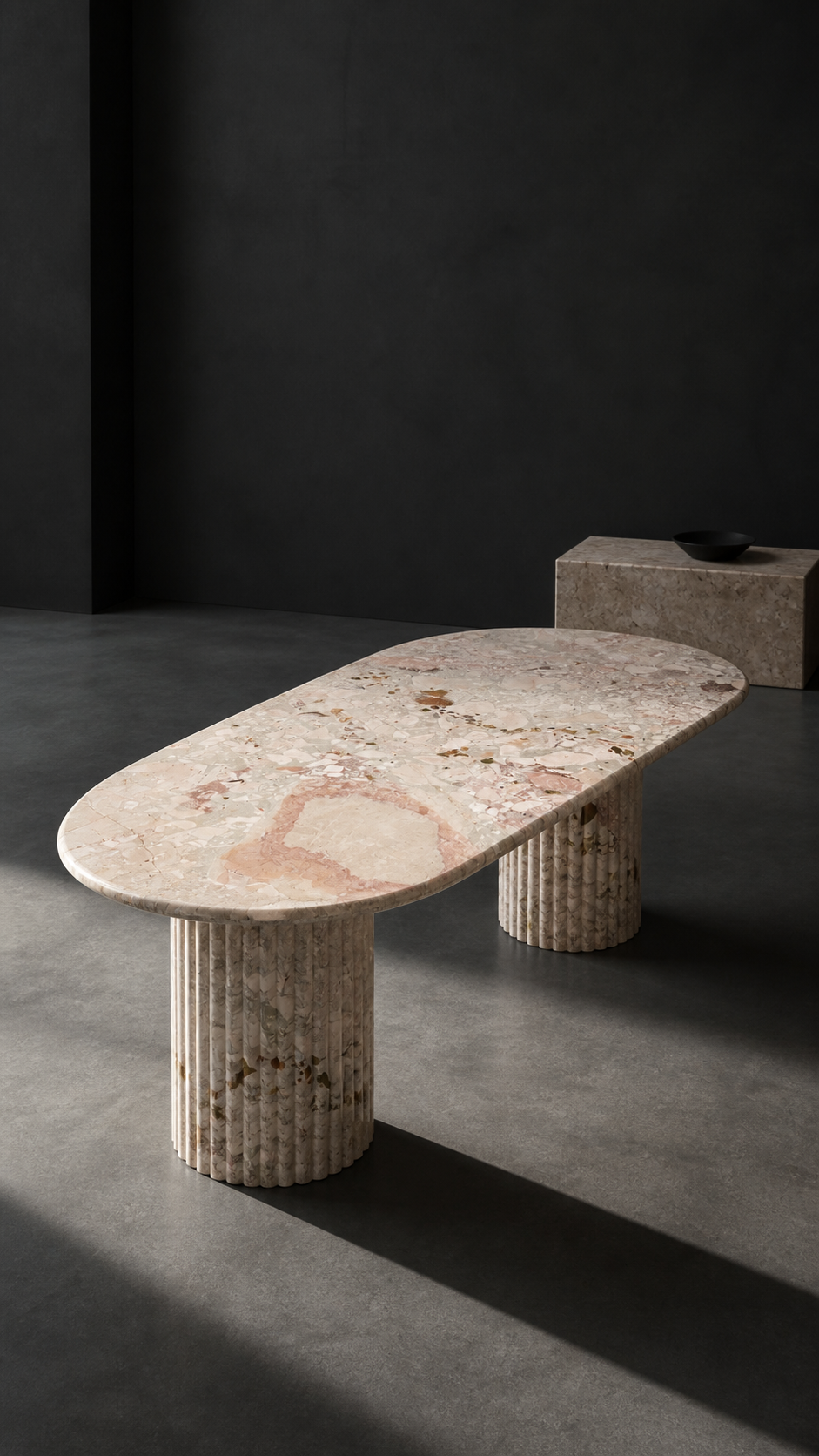Breccia Botticelli oval dining table under directional studio lighting