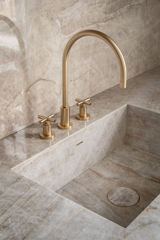Integrated Taj Mahal Quartzite sink with brushed brass fittings