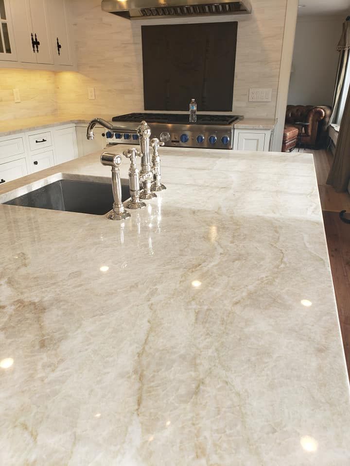 Taj Mahal Quartzite countertop in a warm white traditional kitchen